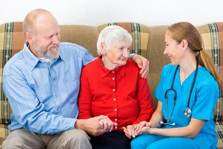 elderly woman and her son with caregiver