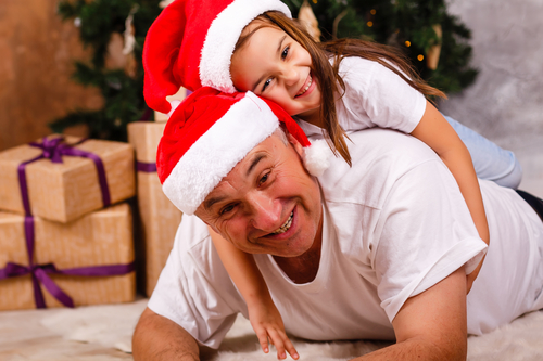 grandfather and granddaughter near the Christmas tree