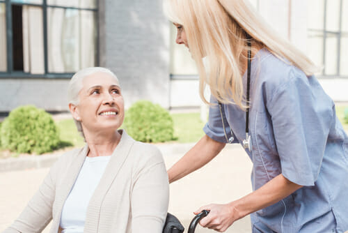 Caregiver with a senior in a wheelchair