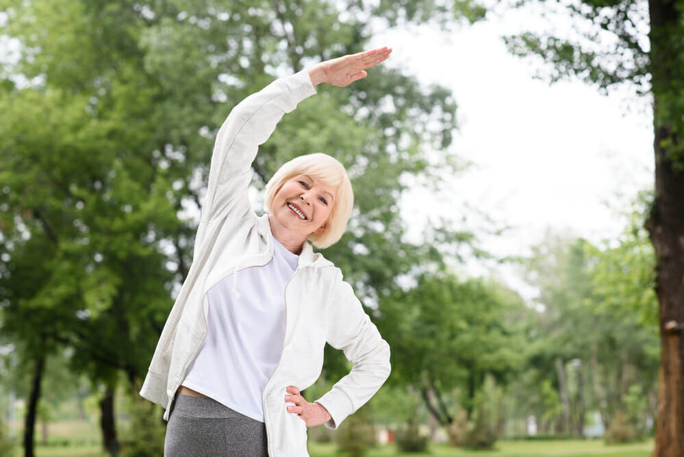 Older woman stretching before exercising